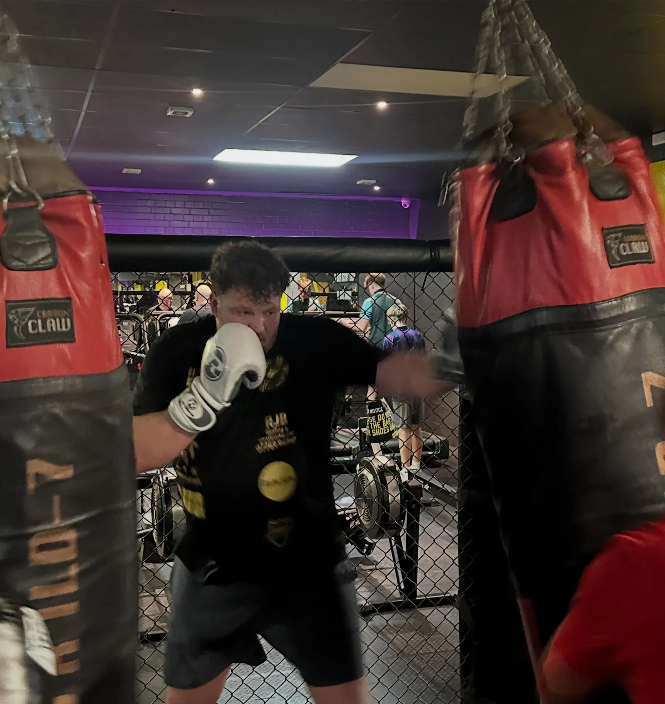 A boxer working a heavy bag