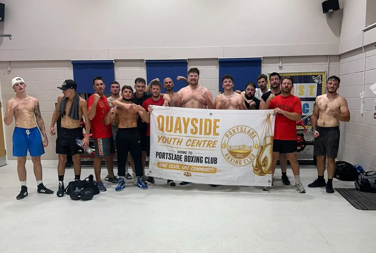 Boxers holding up a Quayside Youth Centre banner that reads Home to Portslade Boxing Club