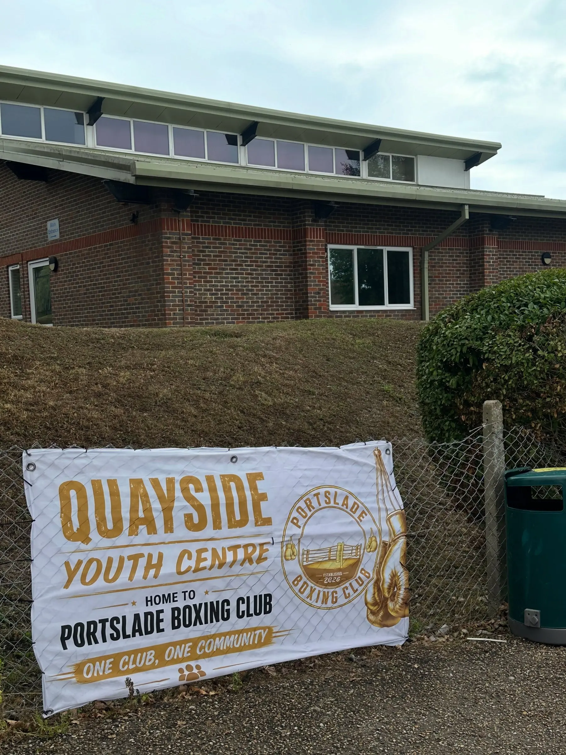 The outside of Quayside Youth Centre with a Home to Portslade Boxing Club banner on the fence