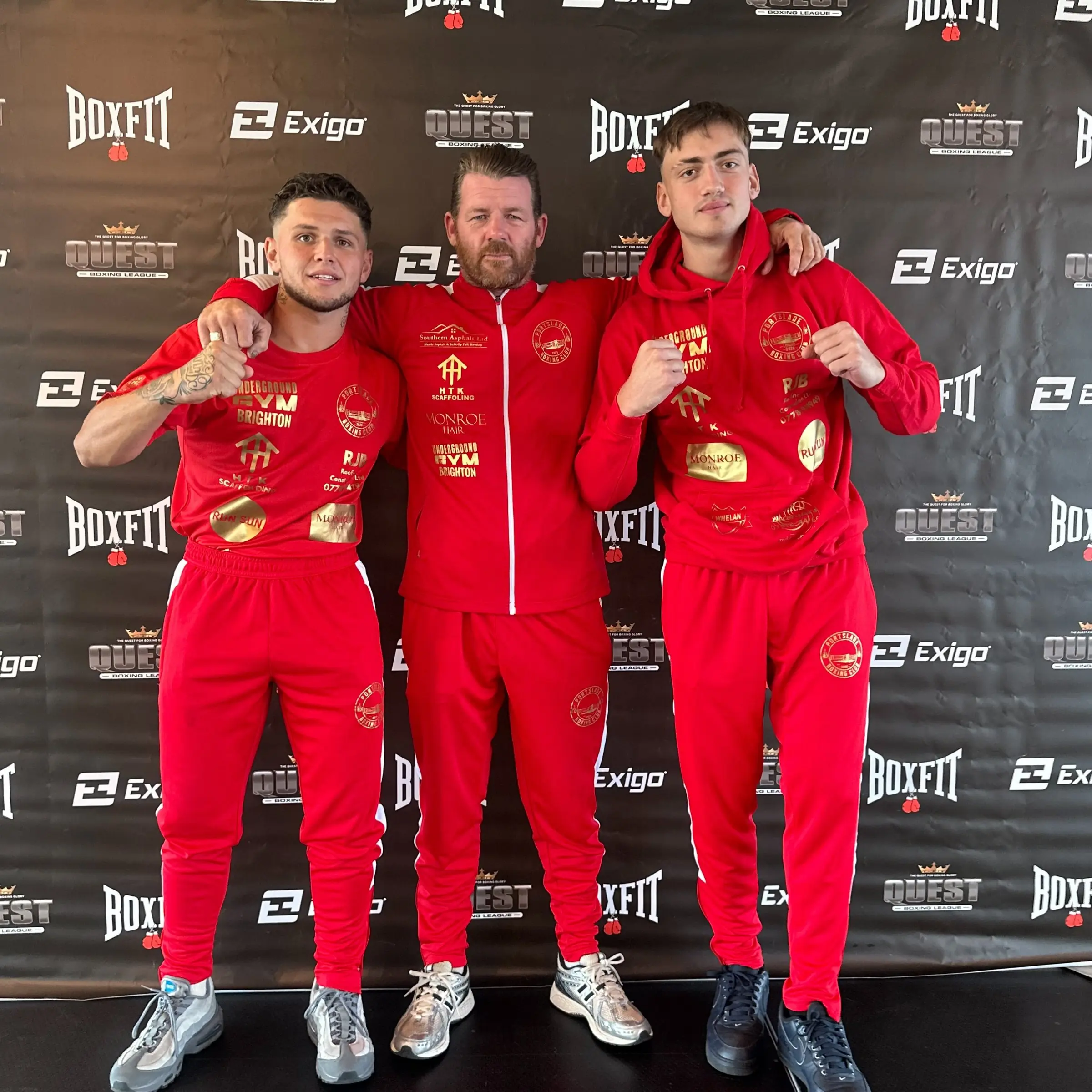 Two boxers and a coach in red tracksuits at a weigh-in